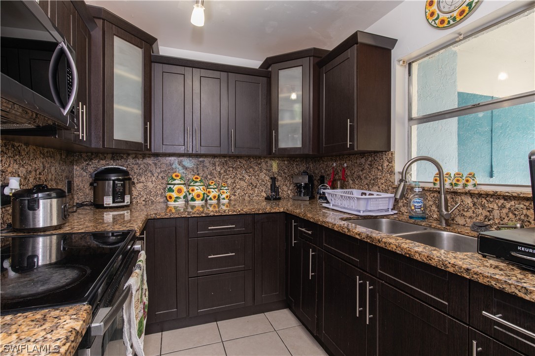 7467-69 Field Road, Unit 69 Fort Myers, FL 33967 - Photo 28 of 35 a kitchen with a sink and cabinets