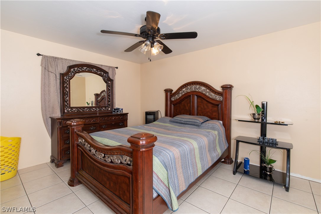 7467-69 Field Road, Unit 69 Fort Myers, FL 33967 - Photo 33 of 35 a bedroom with a bed and a table
