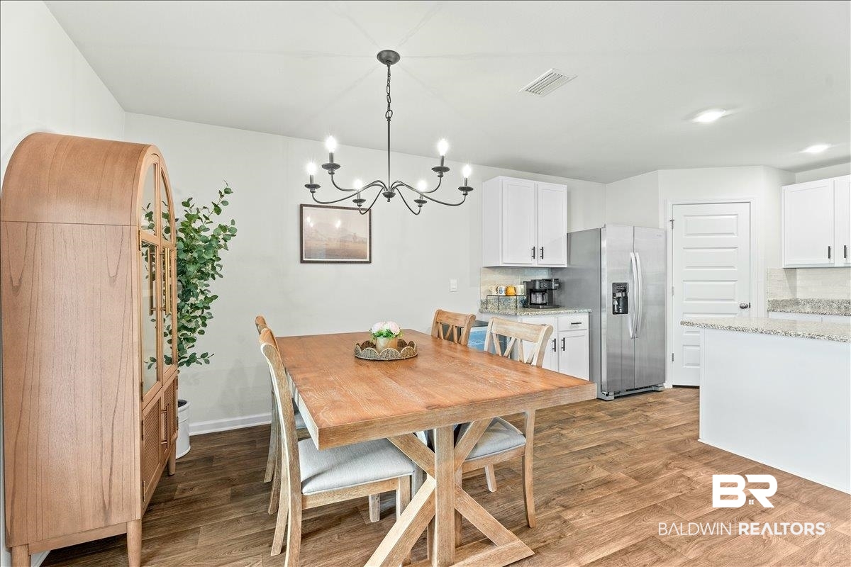 23641 Unbridled Loop Daphne, AL 36526 - Photo 14 of 40 Open-concept living space with wood-finish flooring