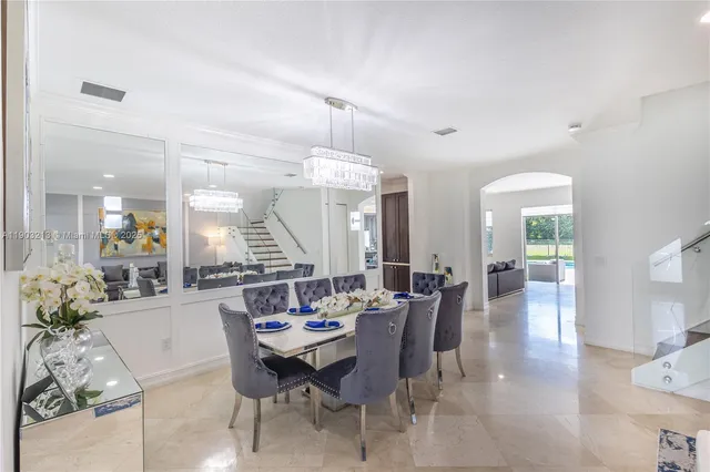 a view of a dining room and livingroom with furniture wooden floor and a rug
