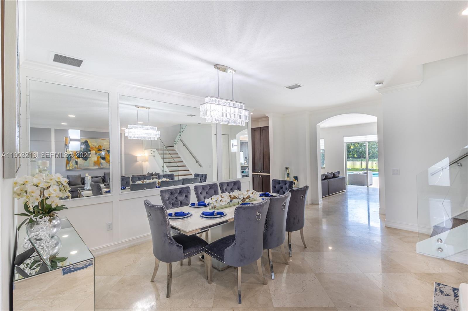 8292 Triana Point Avenue Boynton Beach, FL 33473 - Photo 12 of 60 a dining room with furniture a chandelier and wooden floor