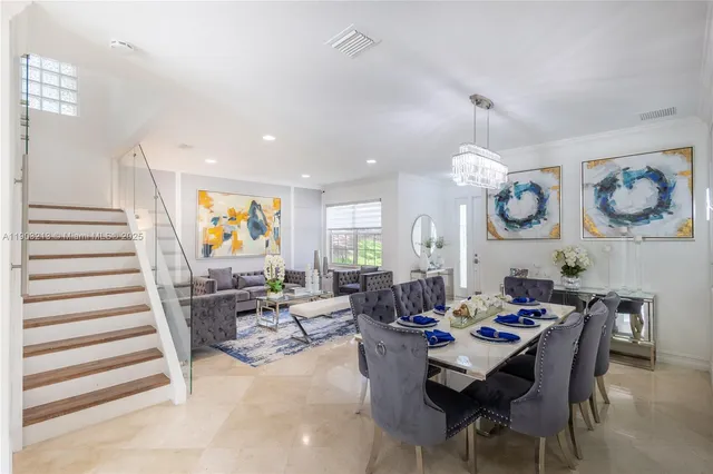 a living room with furniture a window and a flat screen tv