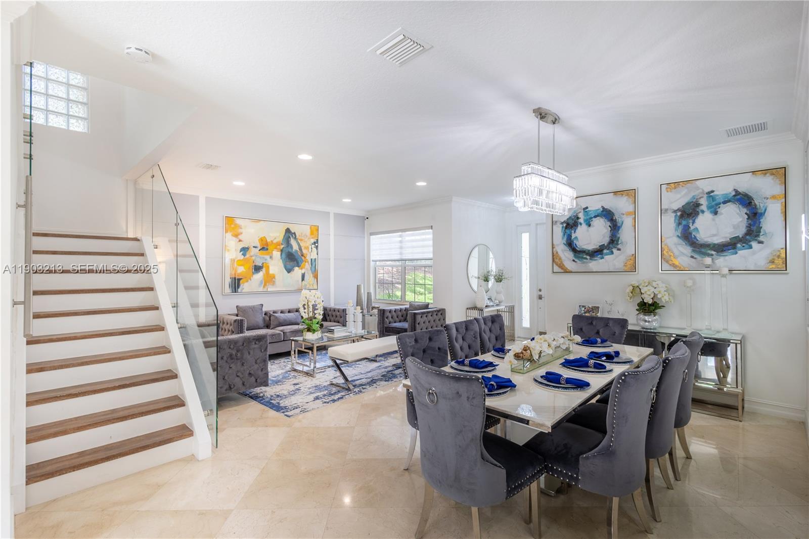 8292 Triana Point Avenue Boynton Beach, FL 33473 - Photo 13 of 60 a view of a dining room and livingroom with furniture wooden floor and a rug
