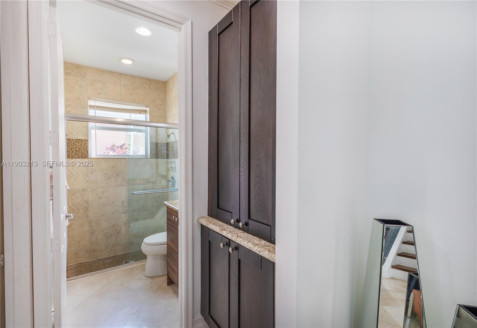 8292 Triana Point Avenue Boynton Beach, FL 33473 - Photo 17 of 60 a bathroom with a granite countertop sink mirror vanity and toilet