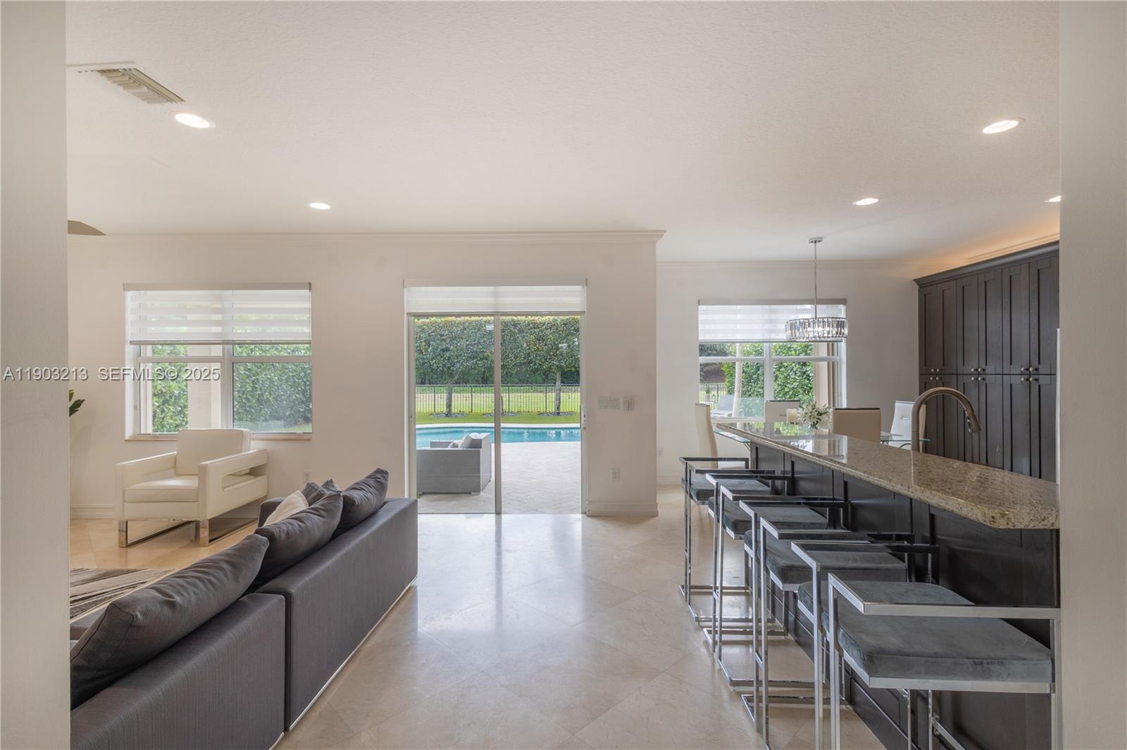 8292 Triana Point Avenue Boynton Beach, FL 33473 - Photo 18 of 60 a living room with furniture and a large window