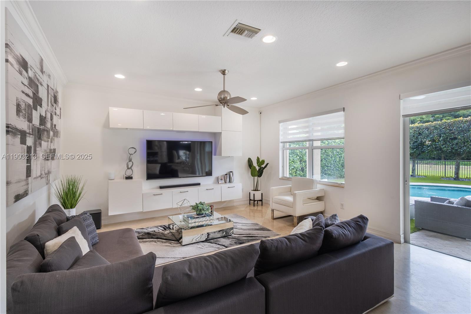 8292 Triana Point Avenue Boynton Beach, FL 33473 - Photo 19 of 60 a living room with furniture and a flat screen tv