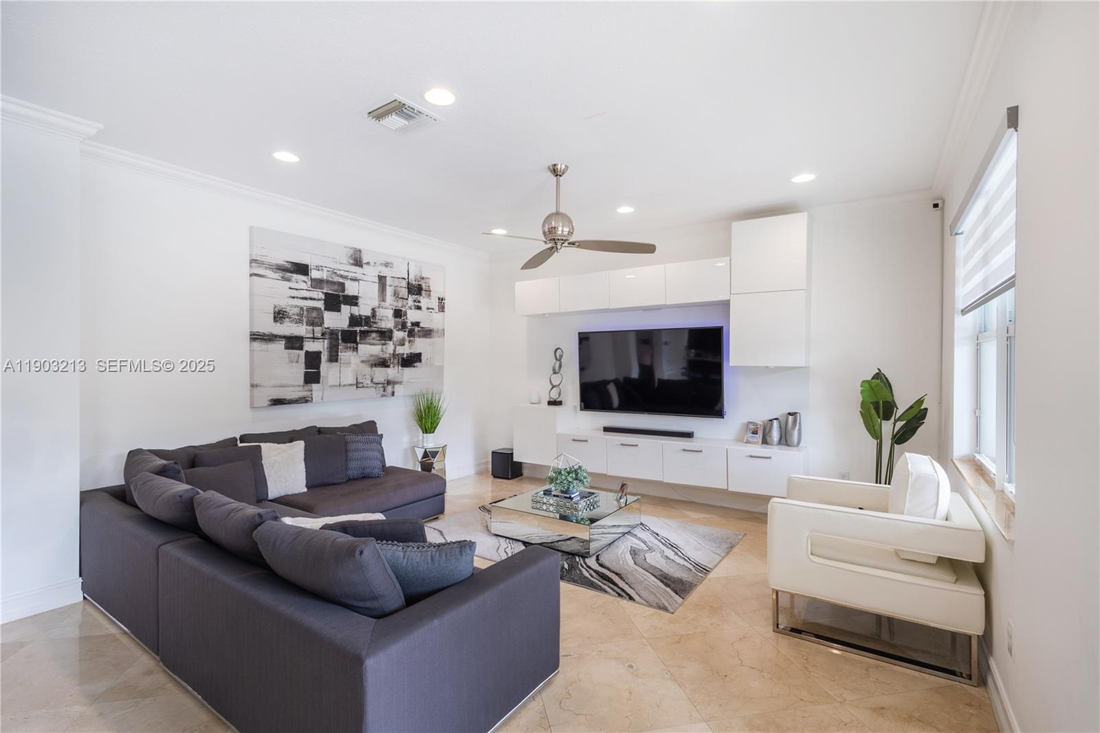 8292 Triana Point Avenue Boynton Beach, FL 33473 - Photo 20 of 60 a living room with furniture and a flat screen tv
