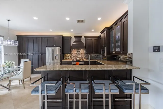 a kitchen with a table and chairs in it