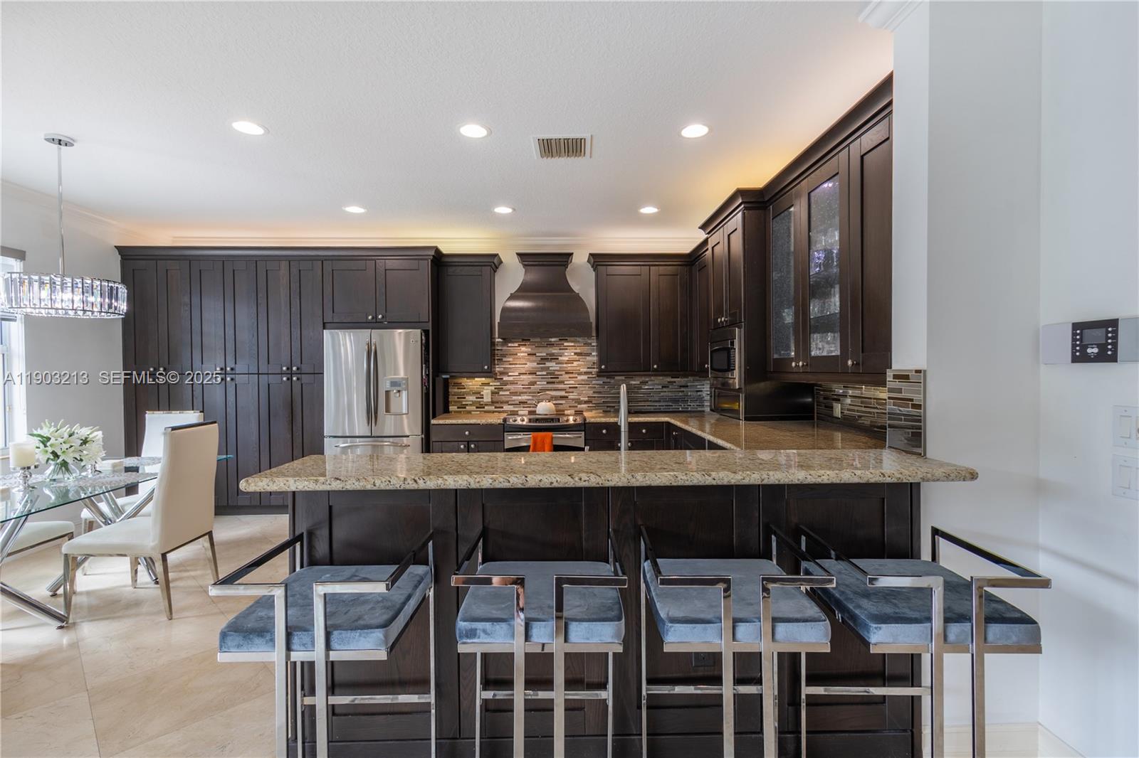 8292 Triana Point Avenue Boynton Beach, FL 33473 - Photo 22 of 60 a kitchen with a table and chairs in it