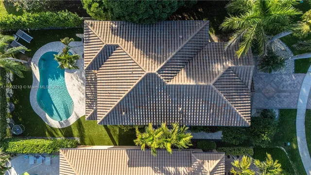 a patio with a table and chairs and potted plants
