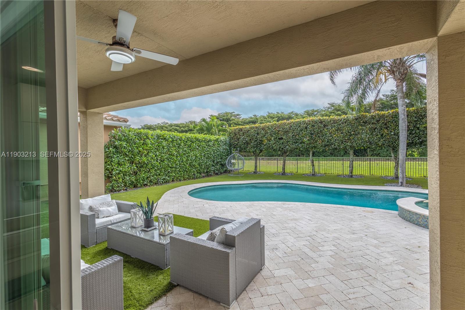 8292 Triana Point Avenue Boynton Beach, FL 33473 - Photo 27 of 60 a view of a porch with furniture and garden