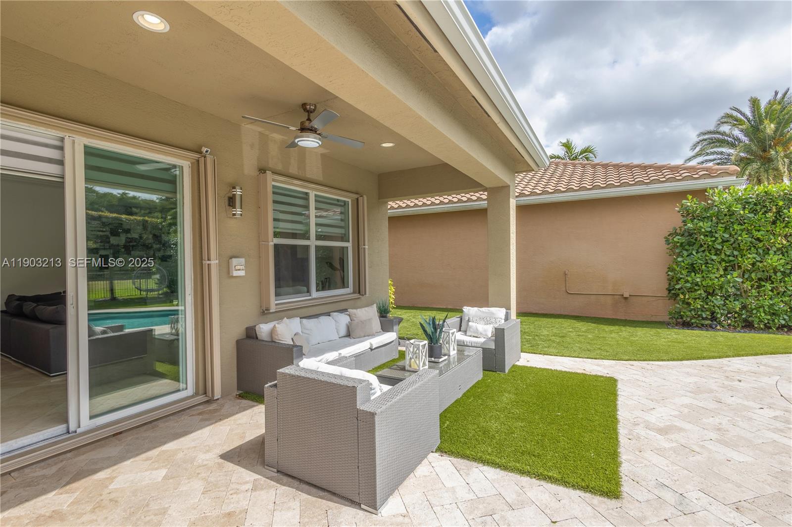 8292 Triana Point Avenue Boynton Beach, FL 33473 - Photo 28 of 60 a patio with a table and chairs and potted plants