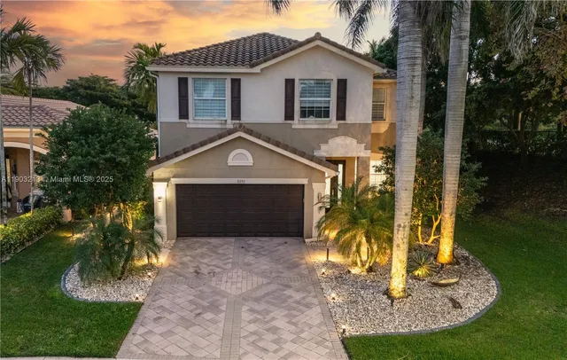 a front view of a house with a yard garage and outdoor seating