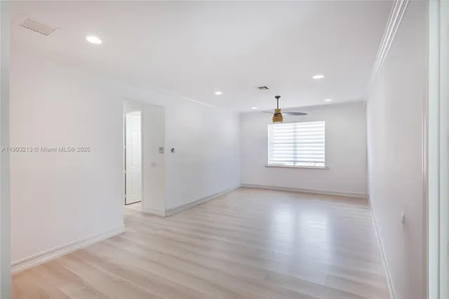 a kitchen with a sink and a stove with white paint