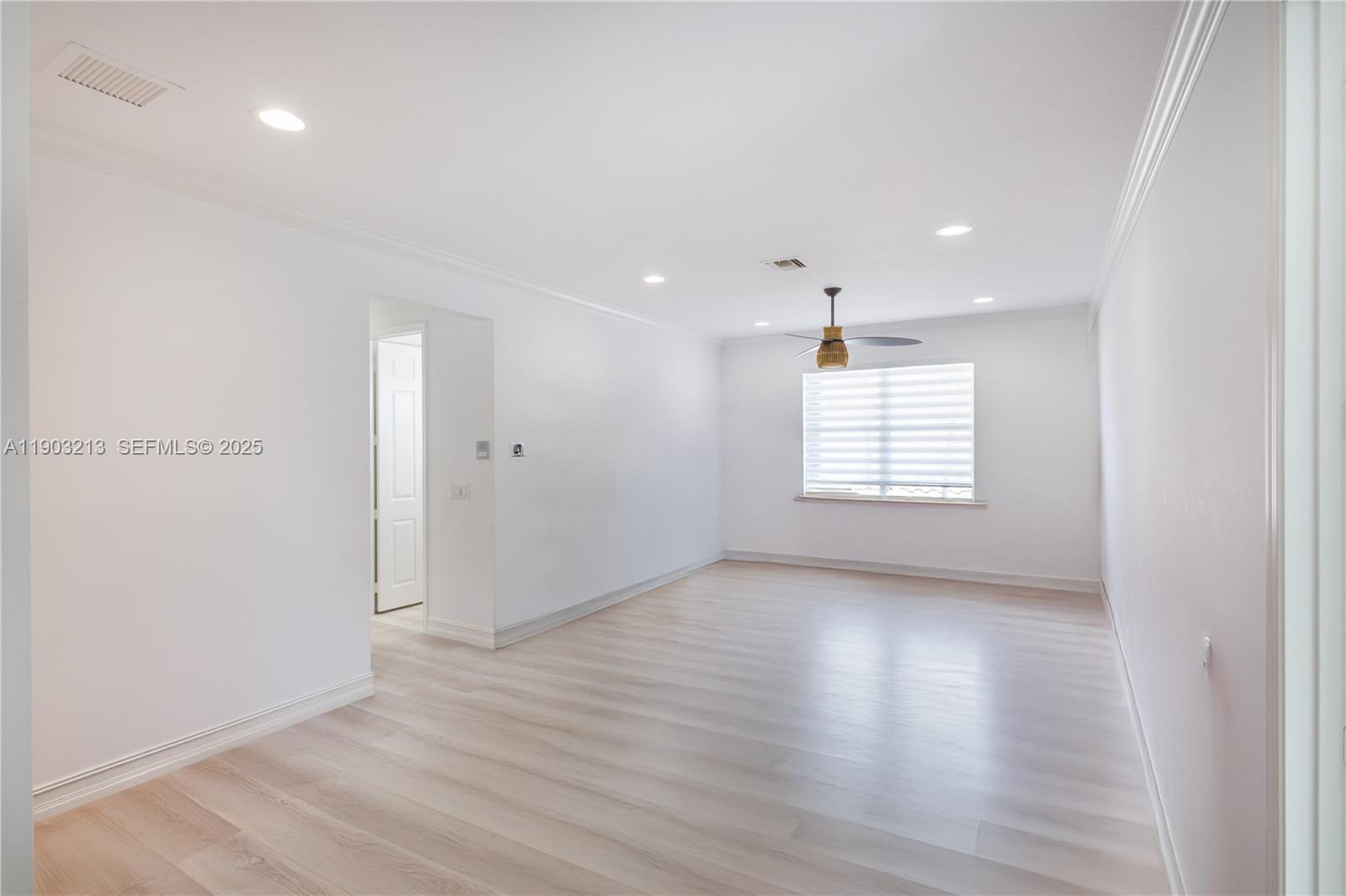 8292 Triana Point Avenue Boynton Beach, FL 33473 - Photo 31 of 60 an empty room with wooden floor and windows