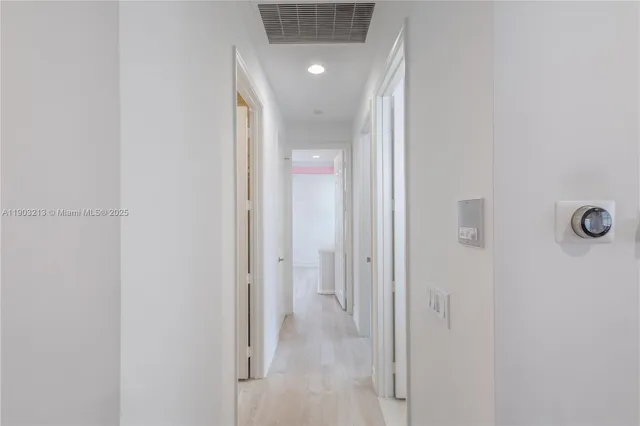 a view of a room that has a bed and a window