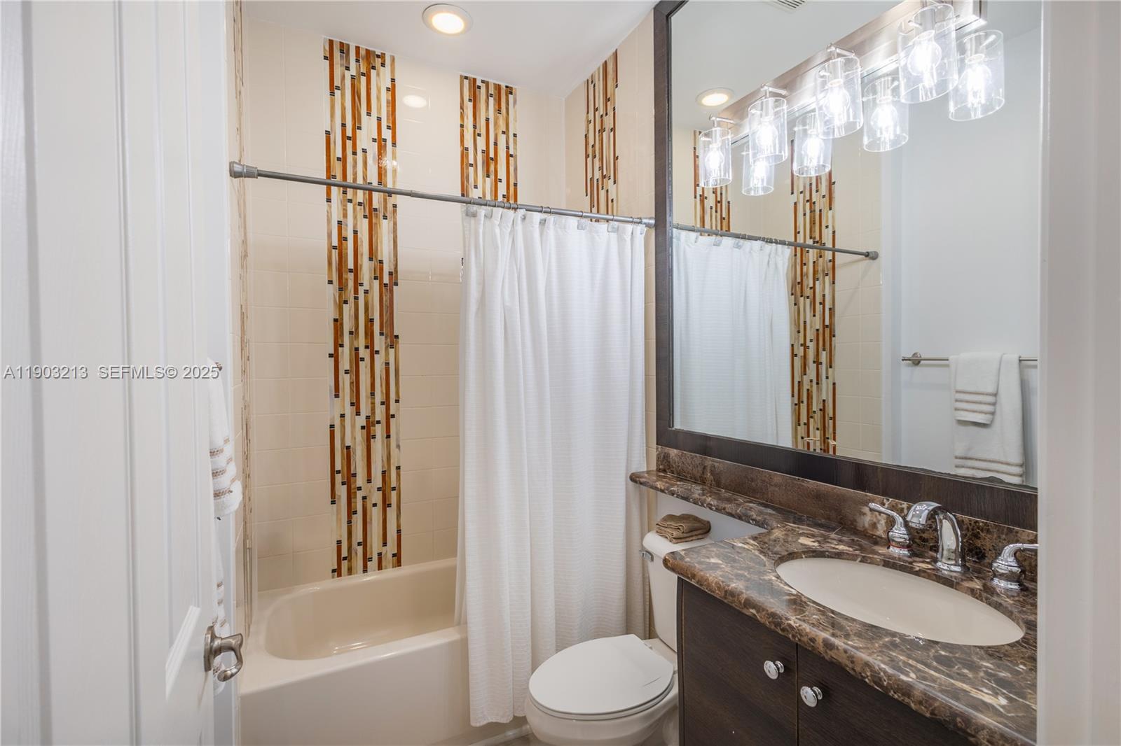 8292 Triana Point Avenue Boynton Beach, FL 33473 - Photo 36 of 60 a bathroom with a granite countertop sink toilet and shower