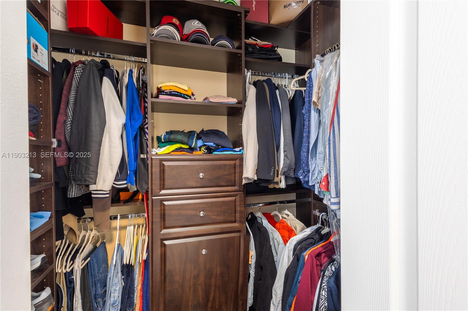 8292 Triana Point Avenue Boynton Beach, FL 33473 - Photo 49 of 60 a view of walk in closet with clothes and shoes