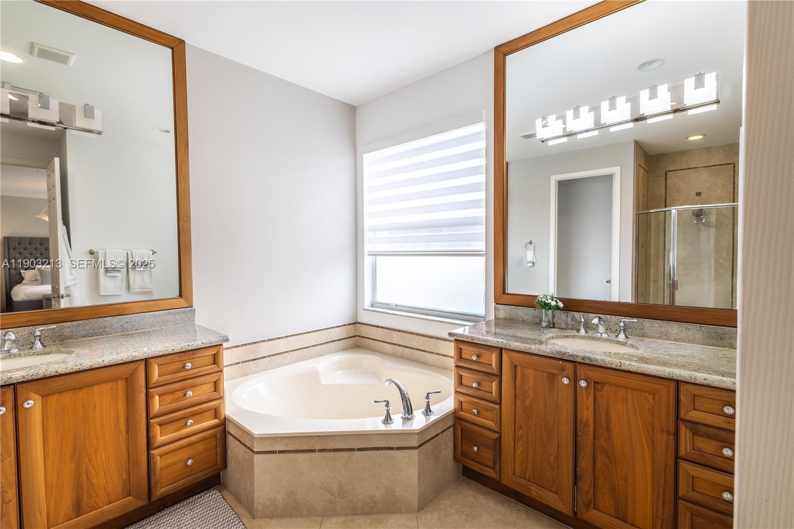 8292 Triana Point Avenue Boynton Beach, FL 33473 - Photo 50 of 60 a bathroom with a granite countertop sink and a mirror