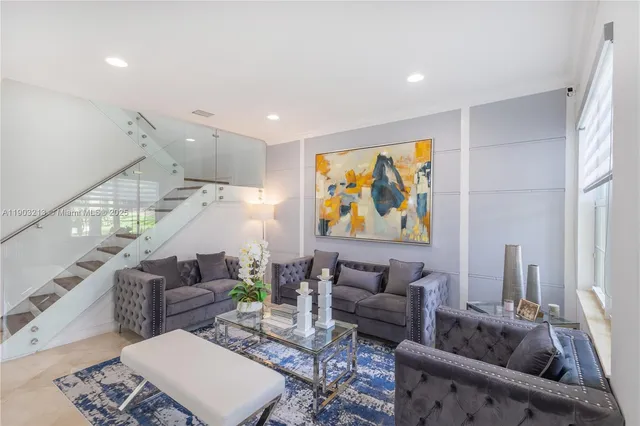 a view of a dining room and livingroom with furniture wooden floor and a rug
