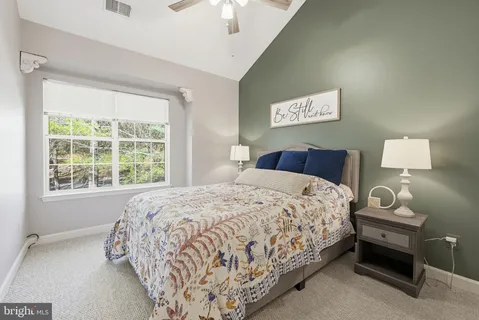 a bedroom with a bed and a lamp