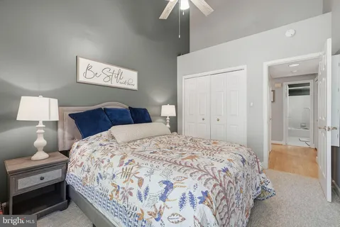 a bedroom with a bed and a lamp