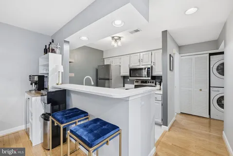 a kitchen with stainless steel appliances a stove refrigerator sink and microwave