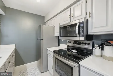 a kitchen with a stove and a refrigerator