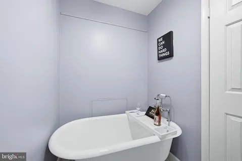 a bathroom with a white wall
