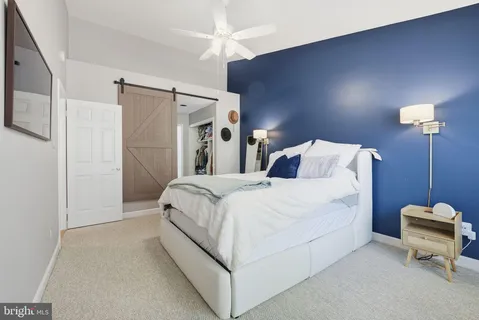 a bedroom with a bed and a mirror