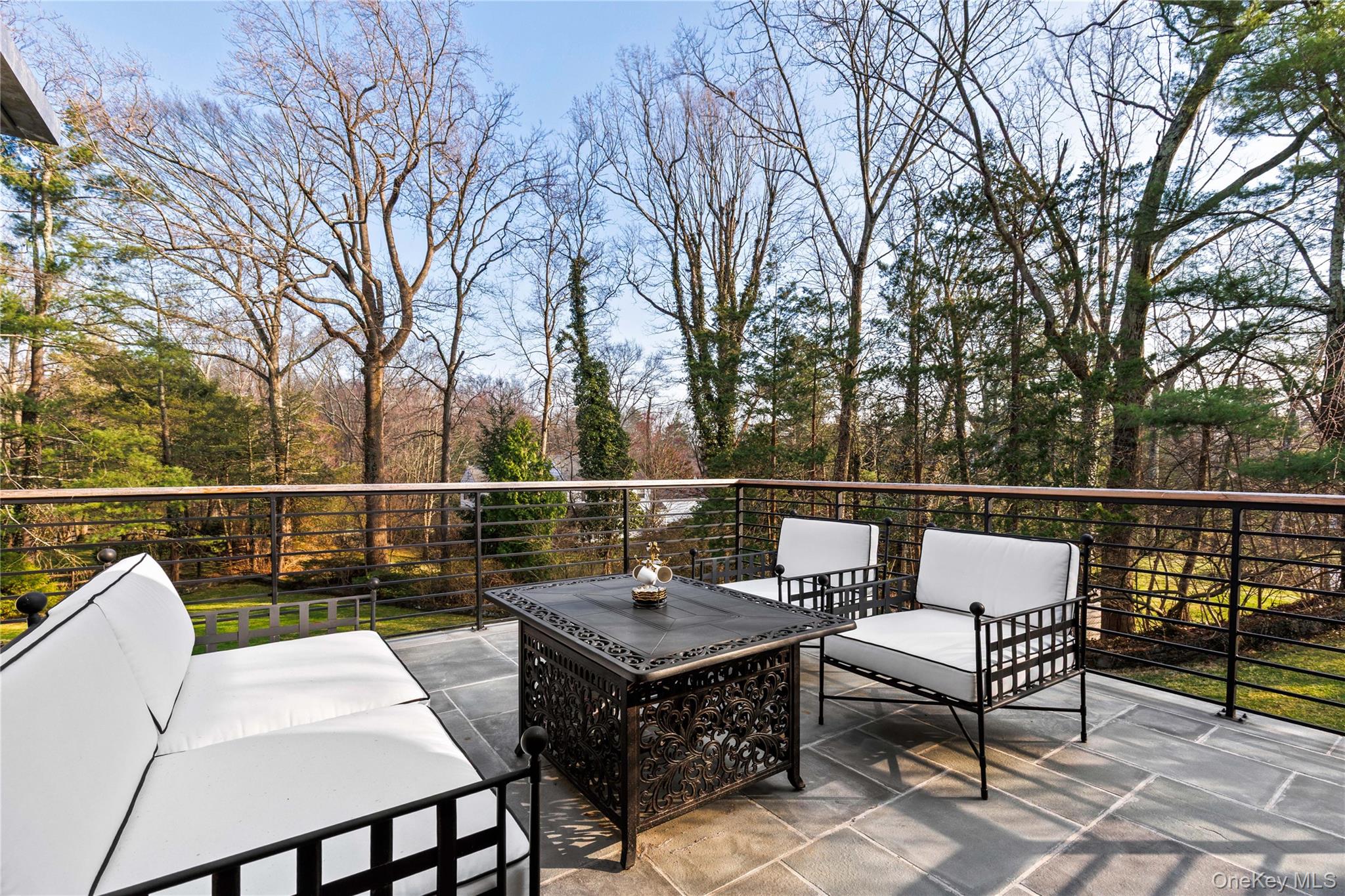 112 Woodlands Road Harrison, NY 10528 - Photo 15 of 43 a balcony with wooden floor table and chairs