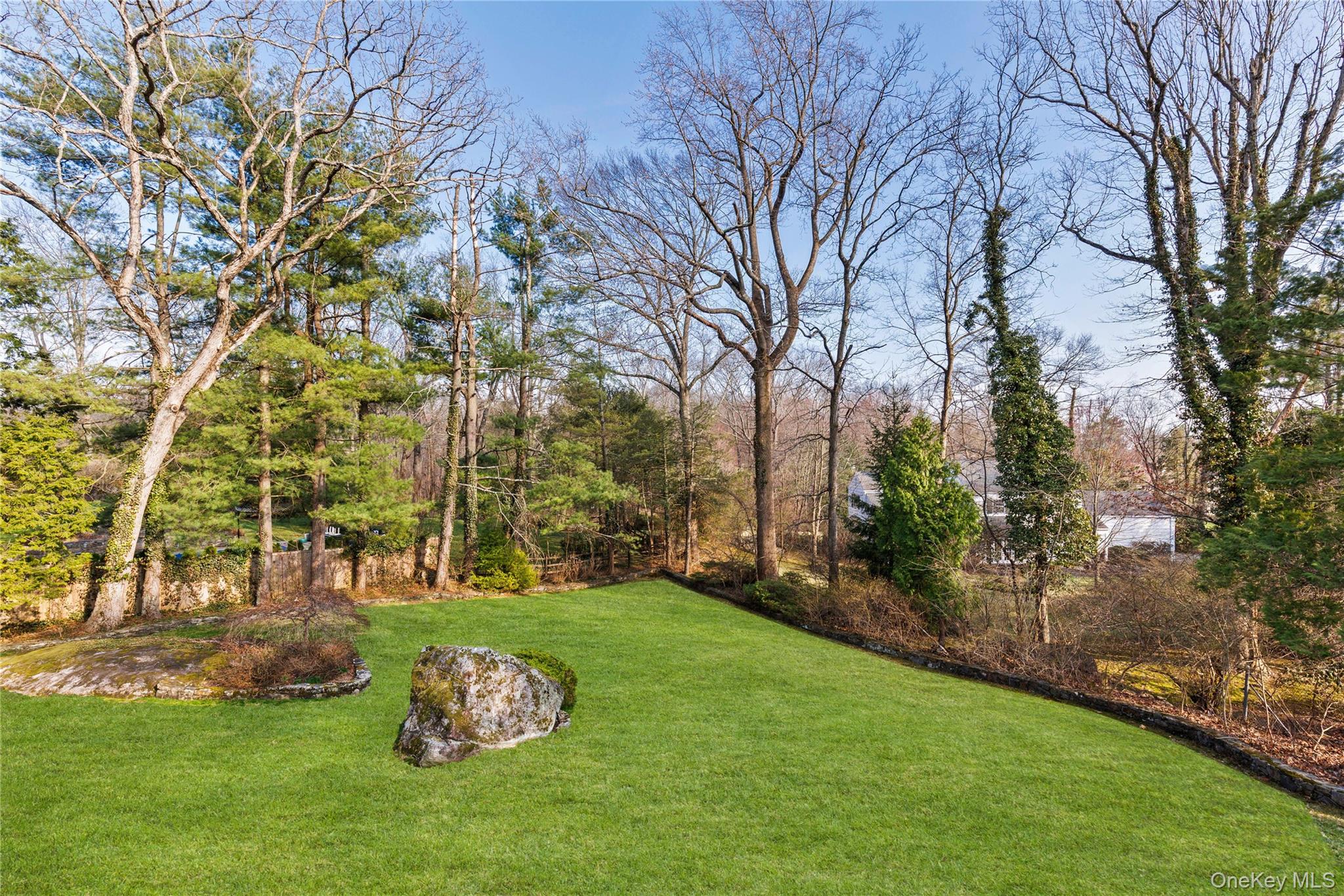 112 Woodlands Road Harrison, NY 10528 - Photo 16 of 43 a green field with lots of trees