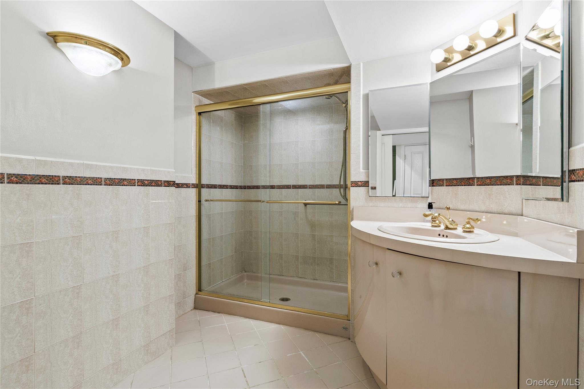112 Woodlands Road Harrison, NY 10528 - Photo 25 of 43 a bathroom with a shower sink and mirror