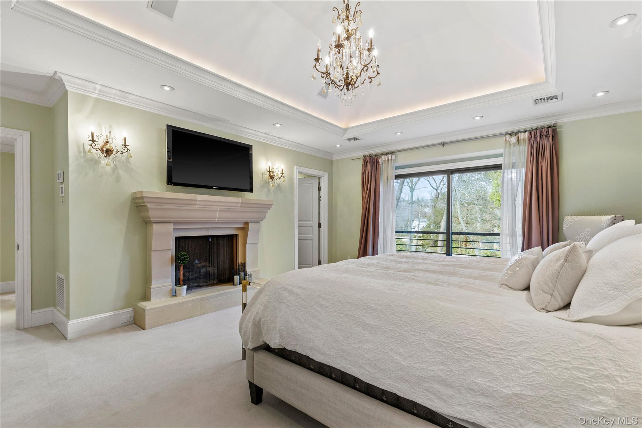 112 Woodlands Road Harrison, NY 10528 - Photo 29 of 43 a spacious bedroom with a large bed and a fireplace