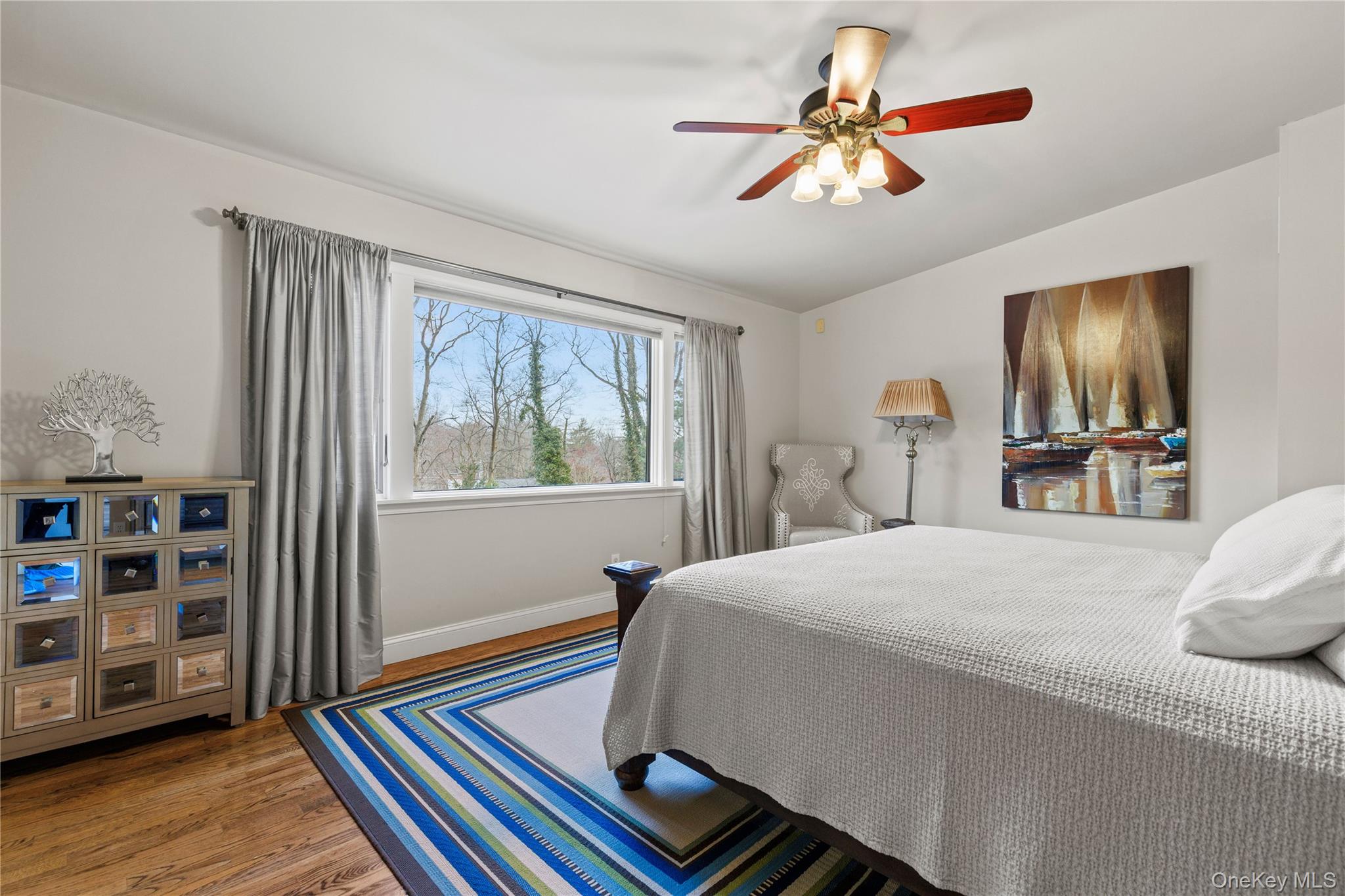 112 Woodlands Road Harrison, NY 10528 - Photo 30 of 43 a bedroom with a bed and a chandelier
