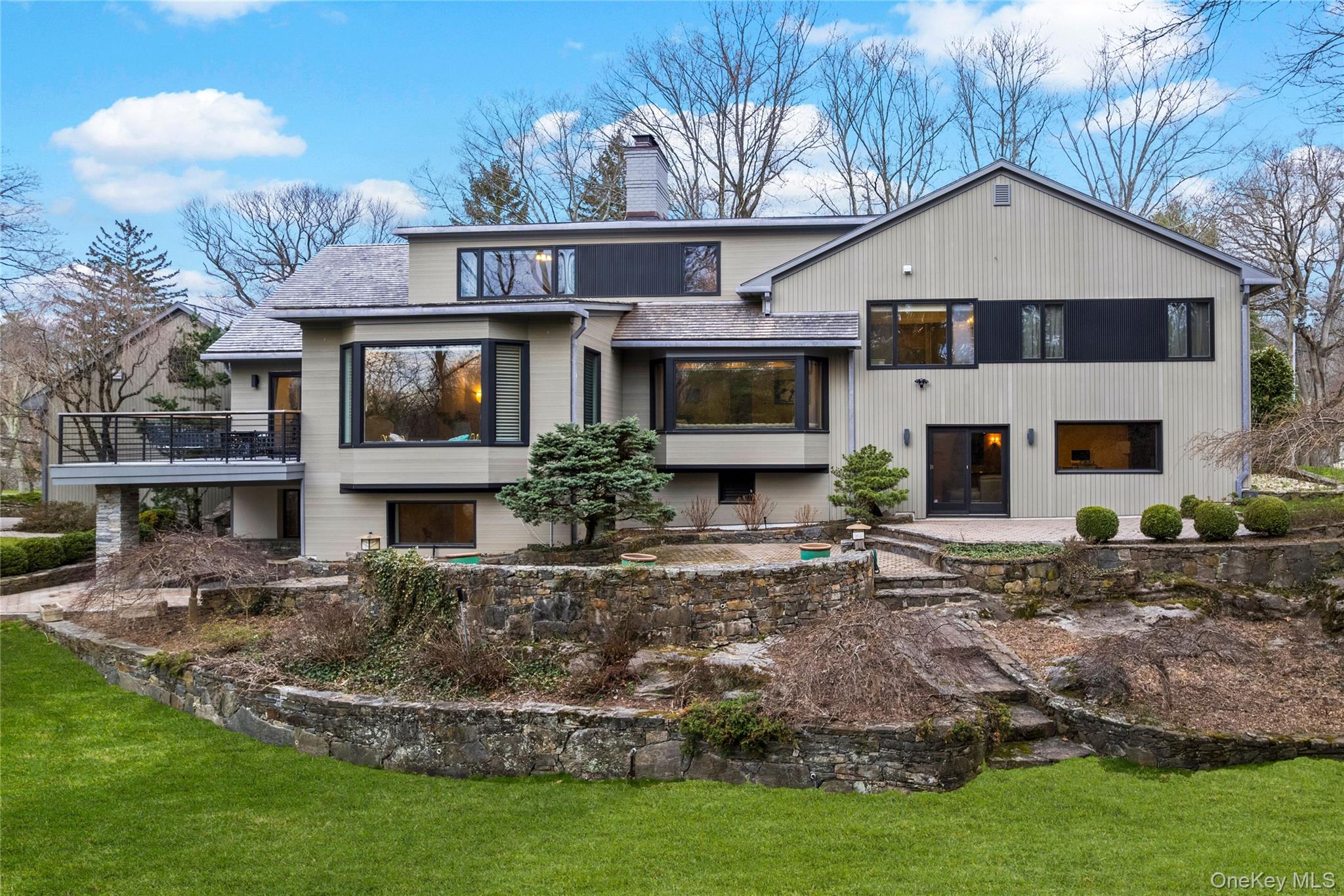112 Woodlands Road Harrison, NY 10528 - Photo 33 of 43 NEW SIDING, VIEW OF CEDAR ROOF, UNDER STONE PILLARS ON LEFT, IS A STONE PATIO.