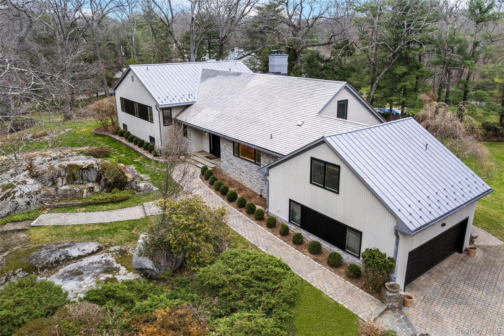 112 Woodlands Road Harrison, NY 10528 - Photo 4 of 43 a aerial view of a house with a yard table and chairs