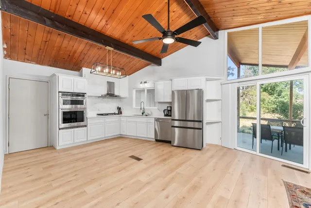 a kitchen with stainless steel appliances a refrigerator and a stove top oven