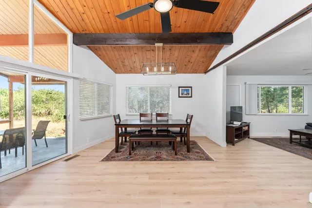 a dining room with furniture window and wooden floor