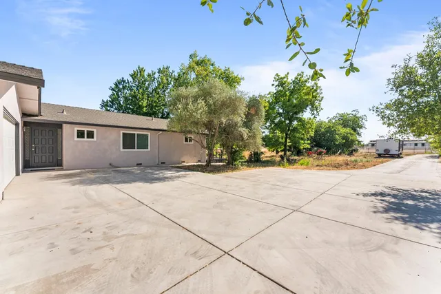 a backyard of a house with a tree