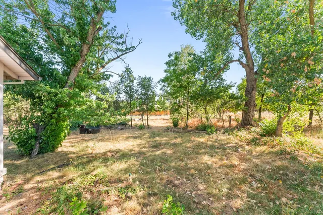 a backyard of a house with table and chairs