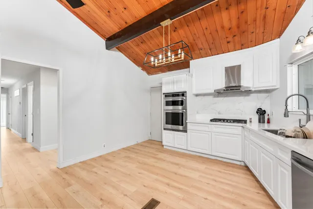 a kitchen with stainless steel appliances granite countertop a stove and a sink