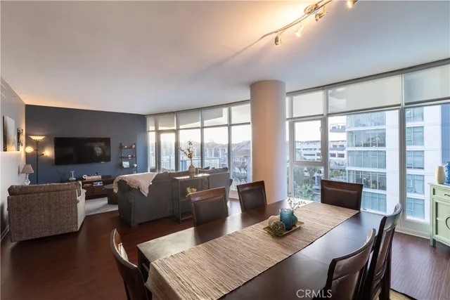 a living room with furniture a flat screen tv and a large window