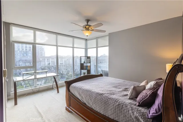 a spacious bedroom with a bed and a large window with outer view