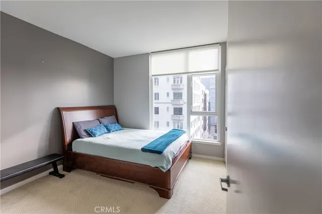 a bedroom with a bed and a window