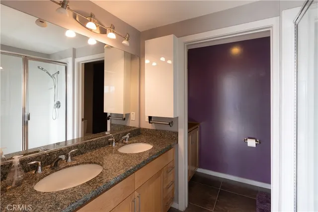 a bathroom with a sink double vanity and a mirror