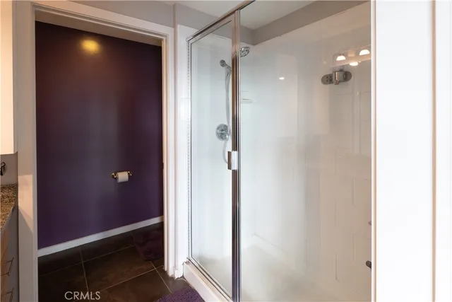 a bathroom with a shower and a glass door