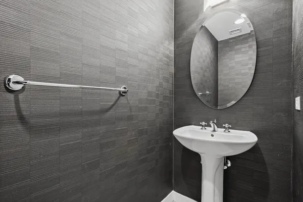 a bathroom with a sink a shower and a mirror