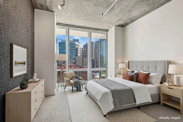 a bedroom with bed and glass windows