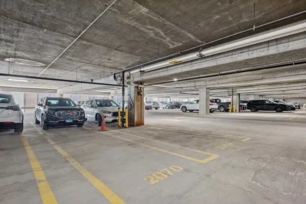 a view of parking garage with cars